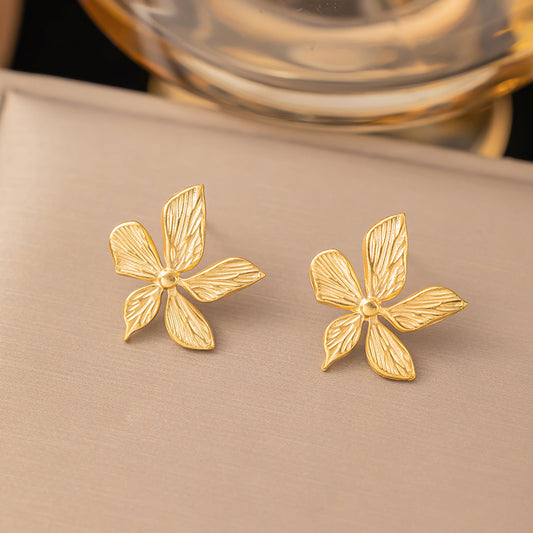 J584 Aretes flor dorada acero de titanio 1.5cm