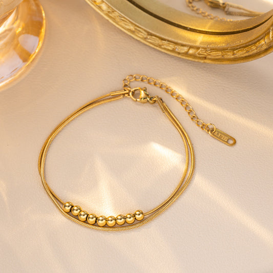 B908 Pulsera doble cuencas dorada acero de titanio 19cm