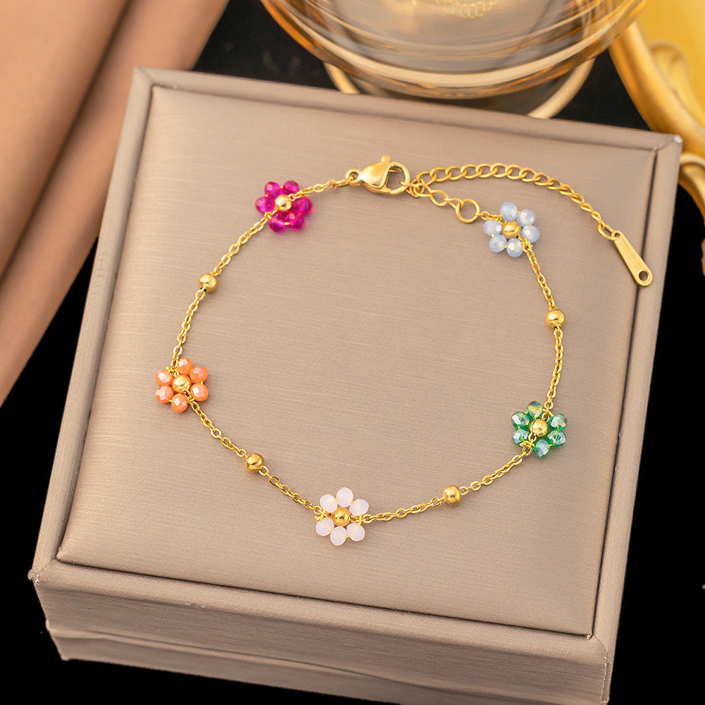 B144 Pulsera flores acero de titanio dorado