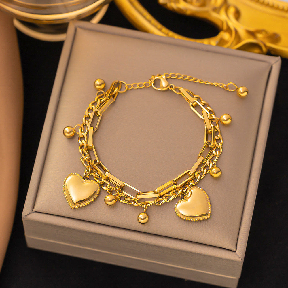 B160 Pulsera corazones acero titanio doble