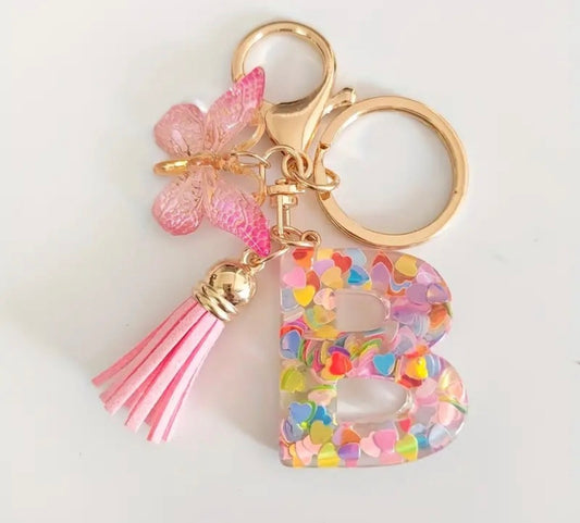 K147 llavero letra B acrílico mariposa rosa