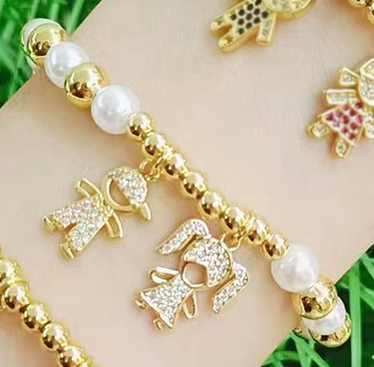 B749 Pulsera cuencas dorada y blancas dije niña y niño