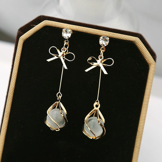 E5931 Aretes moño dorado colgante perla aleacion 6cm